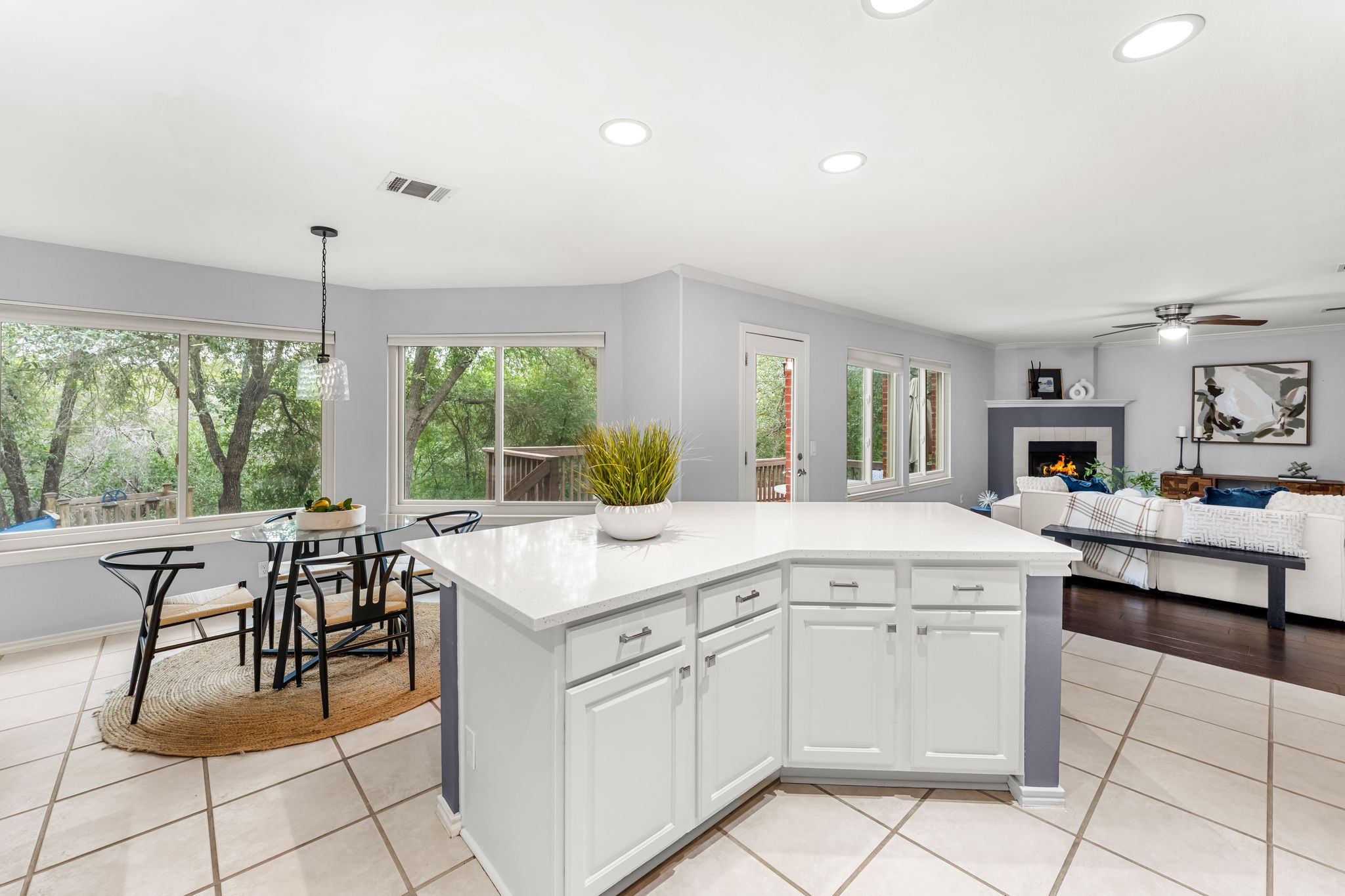 3704 Caney Creek Road Austin, TX 78732 - Photo 12 of 40 A well-lit, open-concept kitchen and living area with ample natural light from extensive windows.