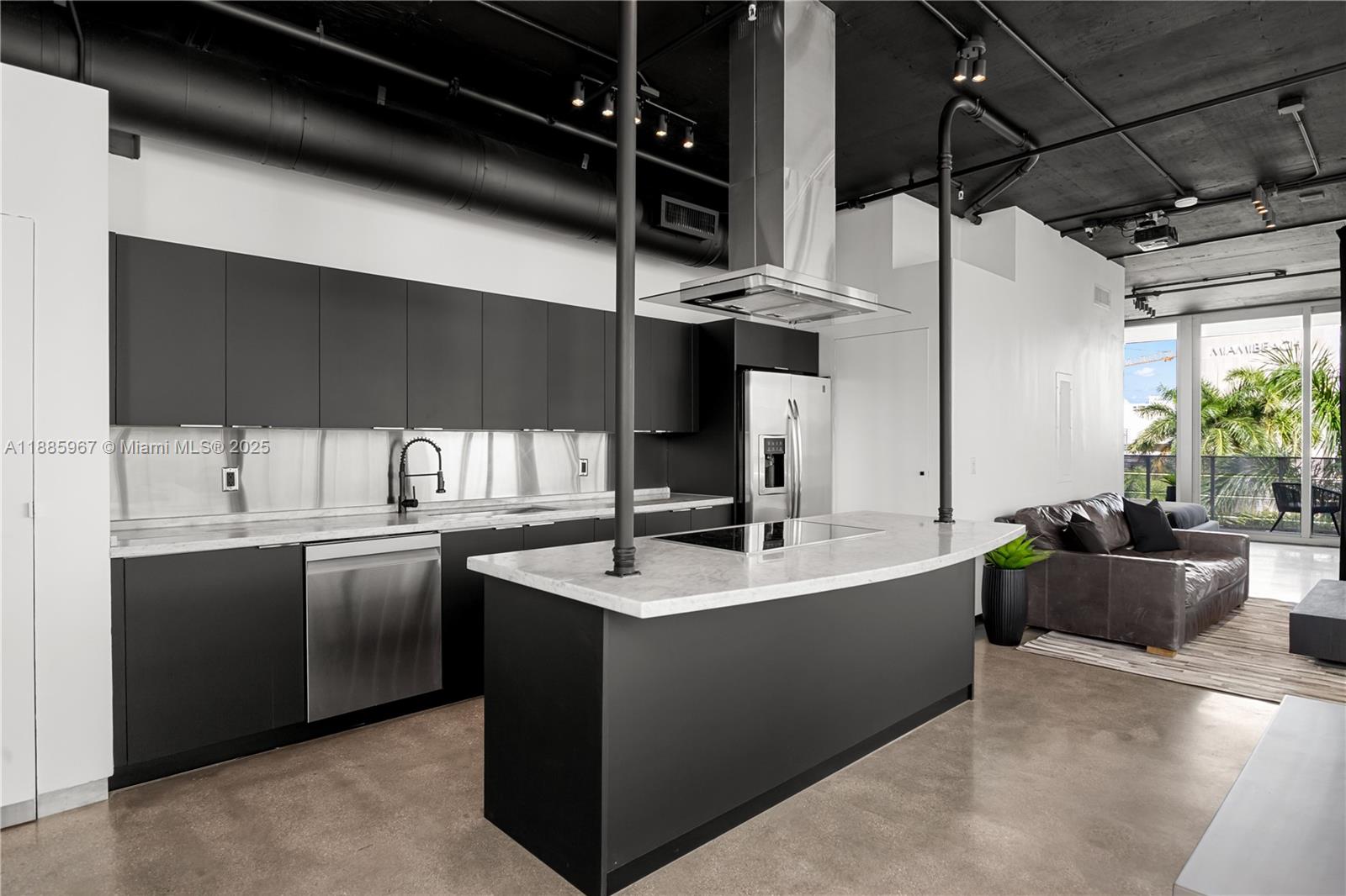 1700 Meridian Avenue, Unit 501 Miami Beach, FL 33139 - Photo 22 of 57 a kitchen with stainless steel appliances granite countertop a sink stove and cabinets