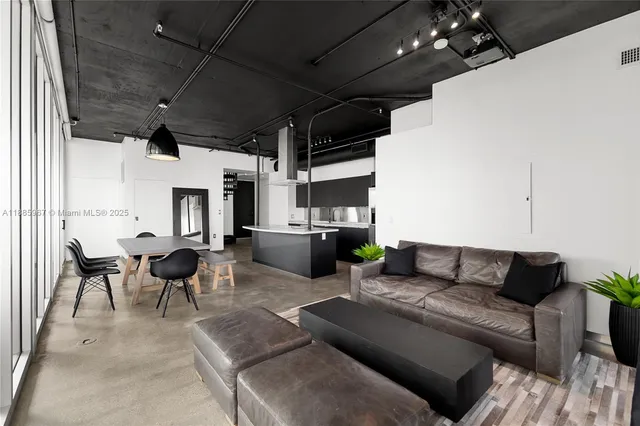 a living room with furniture and large windows