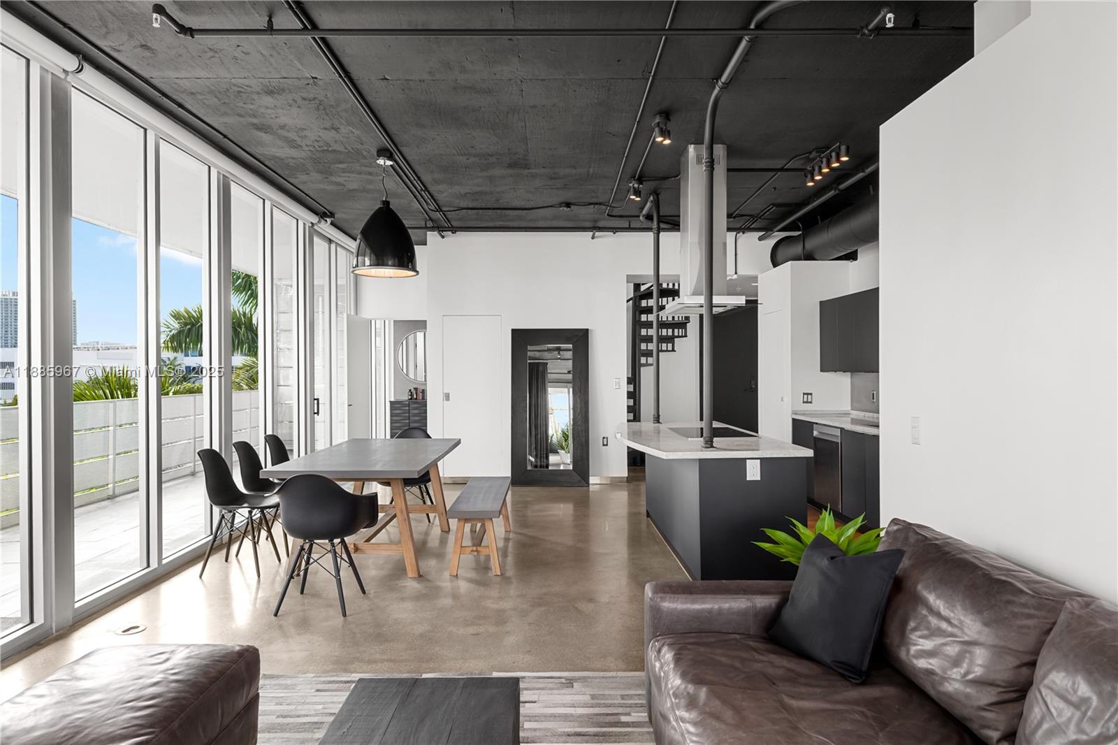1700 Meridian Avenue, Unit 501 Miami Beach, FL 33139 - Photo 26 of 57 a dining room with furniture floor to ceiling window and potted plants