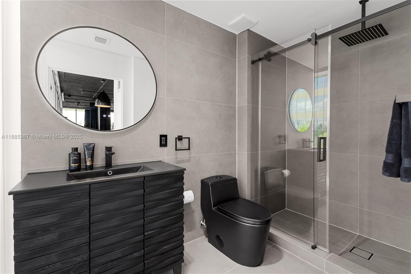 1700 Meridian Avenue, Unit 501 Miami Beach, FL 33139 - Photo 27 of 57 a bathroom with a toilet a sink and mirror