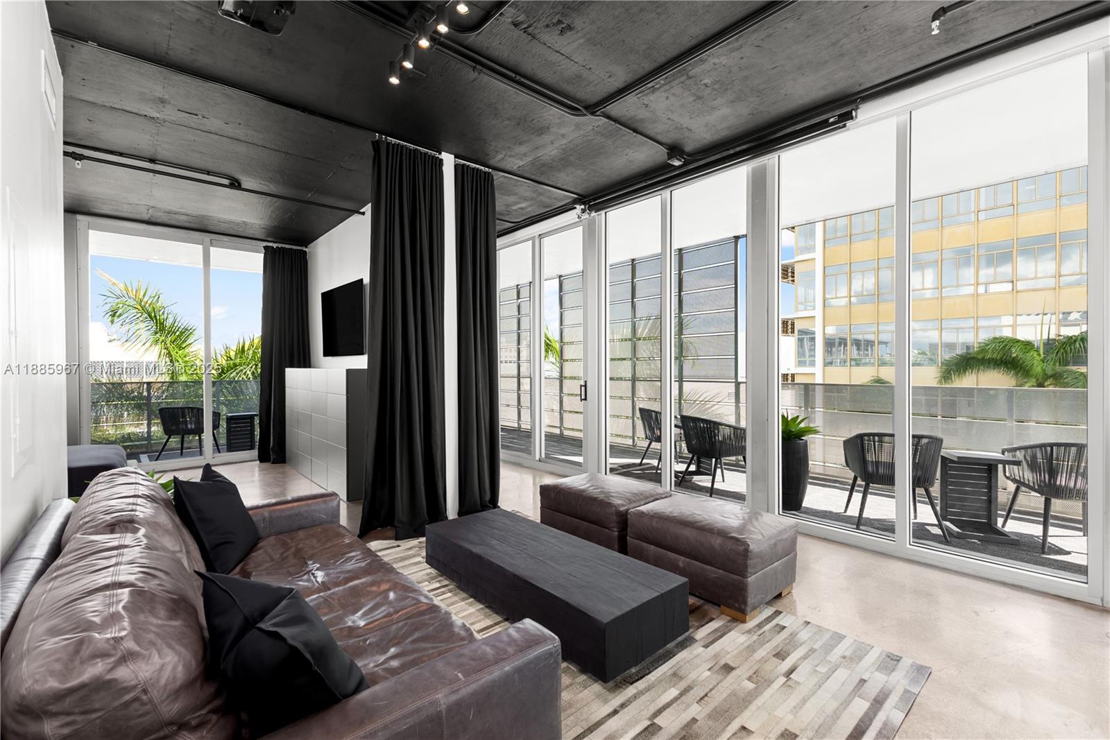 1700 Meridian Avenue, Unit 501 Miami Beach, FL 33139 - Photo 28 of 57 a living room with furniture and large windows
