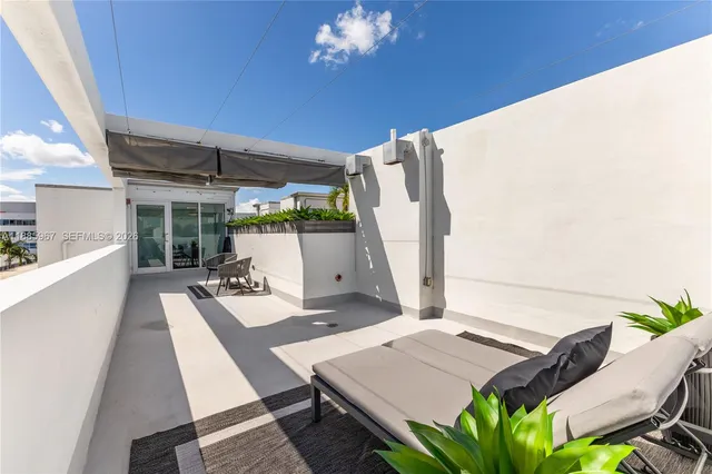 a view of a chairs and table in patio