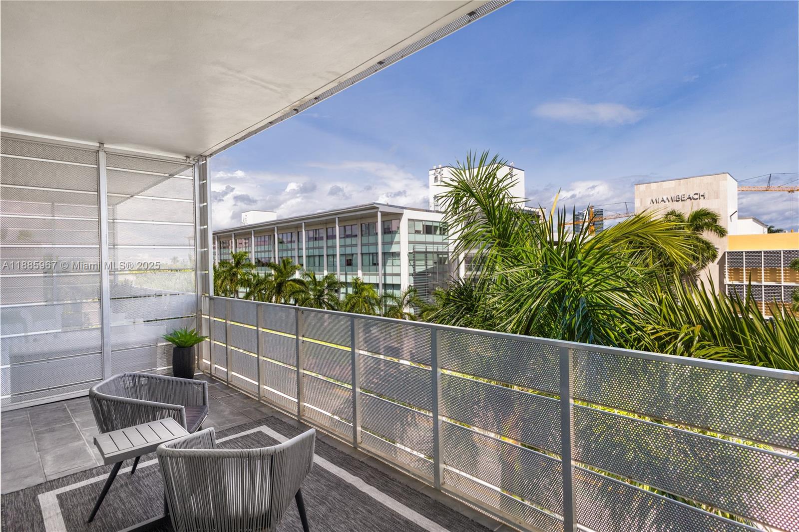 1700 Meridian Avenue, Unit 501 Miami Beach, FL 33139 - Photo 40 of 57 a balcony with table and chairs potted plants