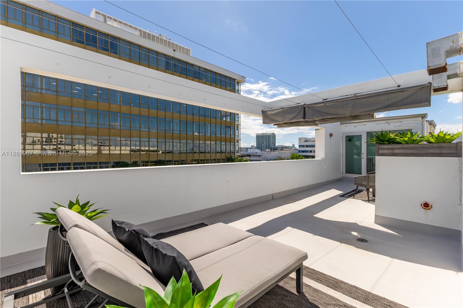 1700 Meridian Avenue, Unit 501 Miami Beach, FL 33139 - Photo 47 of 57 a view of a patio with table and chairs and potted plants