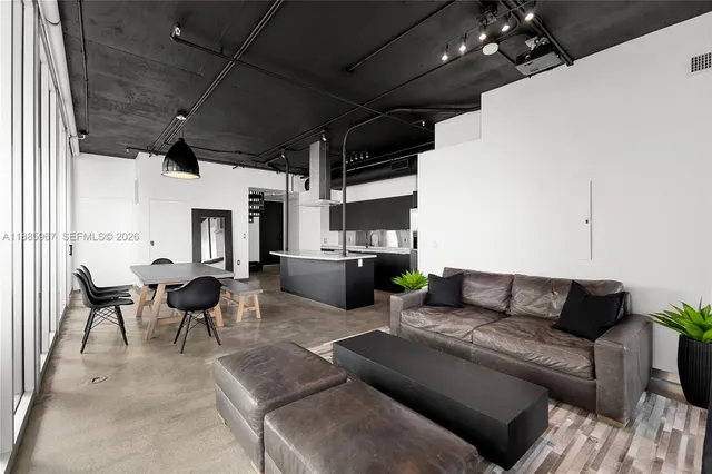 a dining room with furniture floor to ceiling window and potted plants