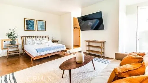 a bedroom with a bed and a flat screen tv