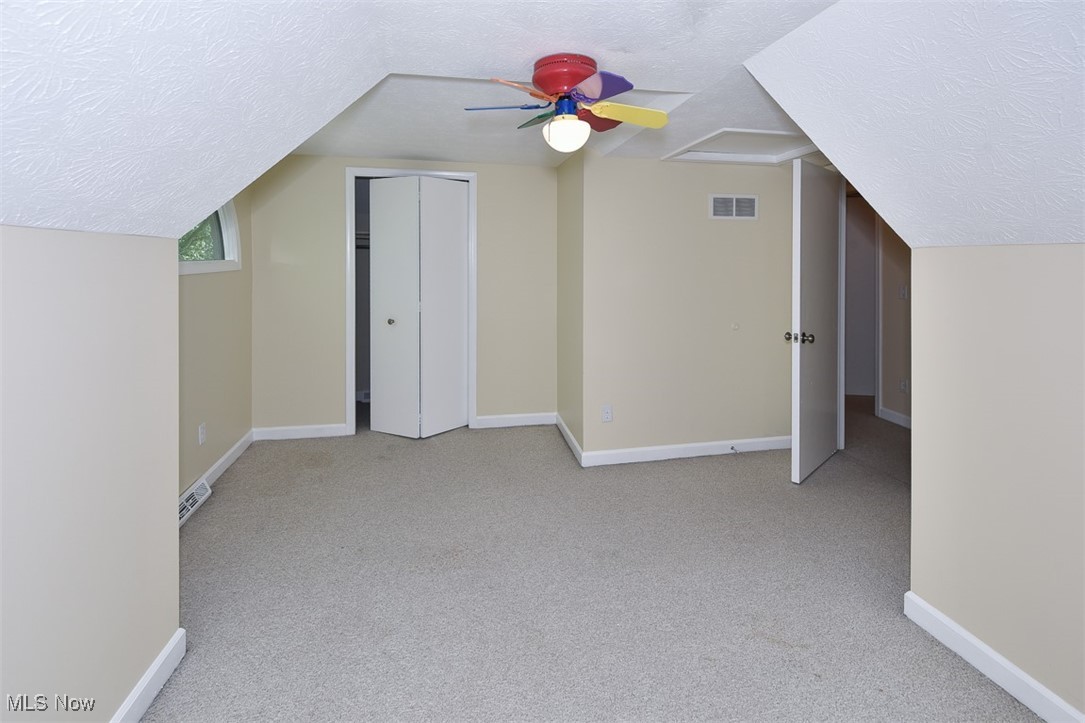 30776 Cedar Road Cleveland, OH 44124 - Photo 28 of 41 Bonus room with a textured ceiling, carpet, and vaulted ceiling