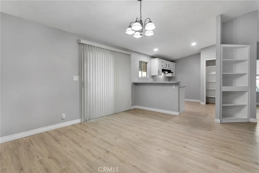 8450 G, Unit 63 Hesperia, CA 92345 - Photo 13 of 31 a view of a kitchen with a sink and dishwasher a refrigerator with wooden floor