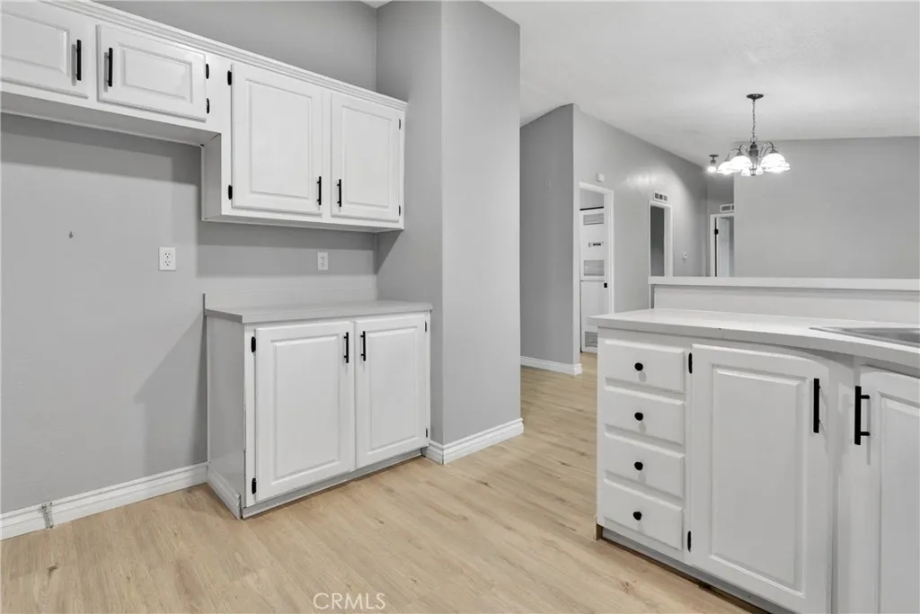 8450 G, Unit 63 Hesperia, CA 92345 - Photo 17 of 31 a view of cabinets and wooden floor