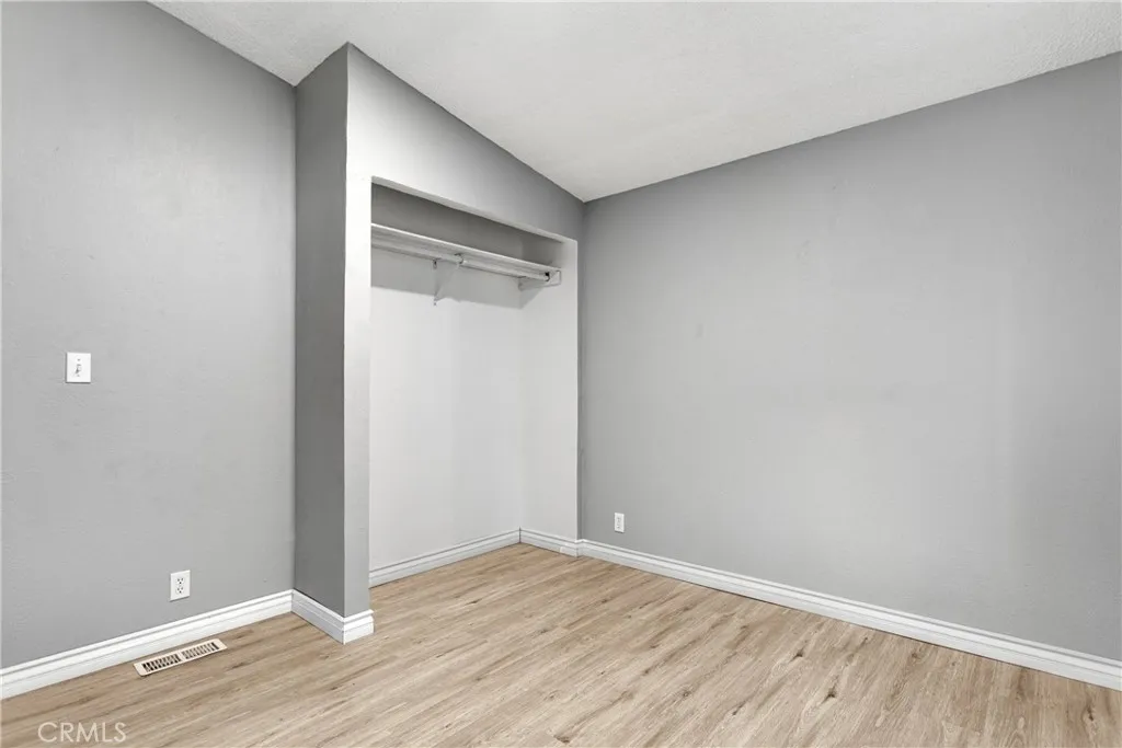8450 G, Unit 63 Hesperia, CA 92345 - Photo 19 of 31 a view of an empty room with wooden floor
