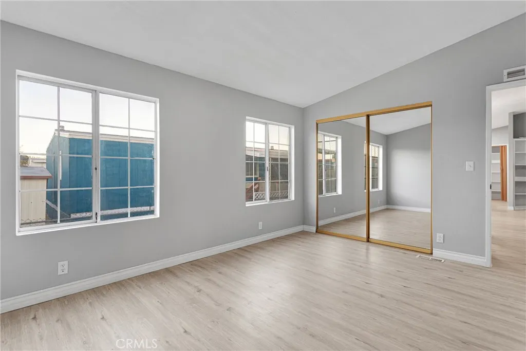 8450 G, Unit 63 Hesperia, CA 92345 - Photo 21 of 31 a view of an empty room with wooden floor and a window