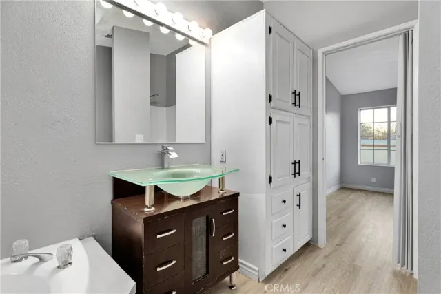 a bathroom with a granite countertop sink a mirror and a shower