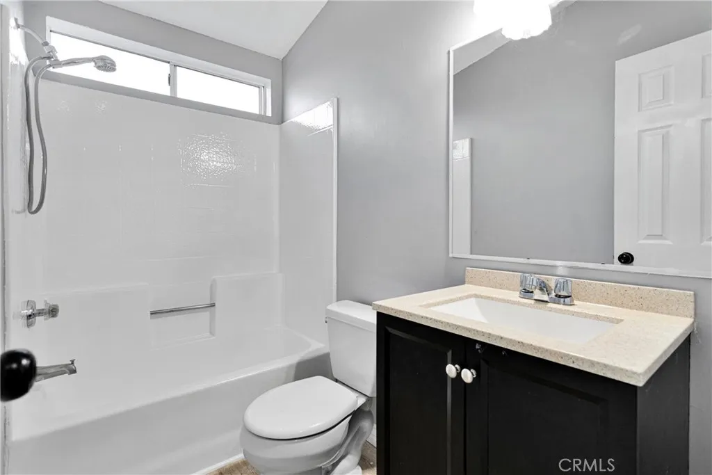 8450 G, Unit 63 Hesperia, CA 92345 - Photo 25 of 31 a bathroom with a sink a toilet and shower