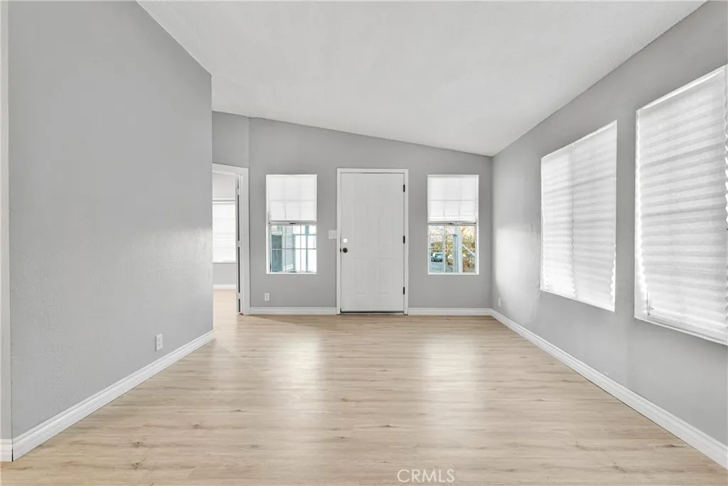 8450 G, Unit 63 Hesperia, CA 92345 - Photo 8 of 31 an empty room with wooden floor and windows