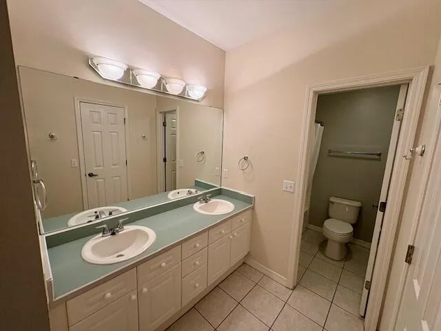 a bathroom with a sink double vanity and a toilet