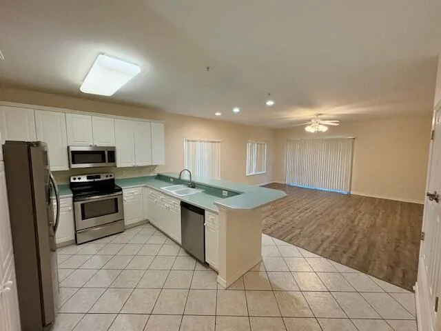a kitchen with granite countertop a sink and steel appliances