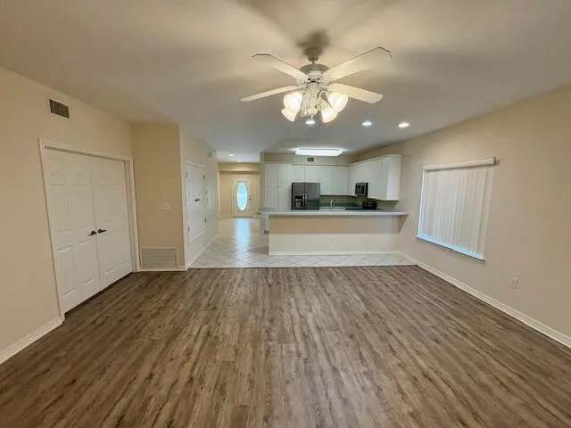 a view of a kitchen with a sink and wooden floor