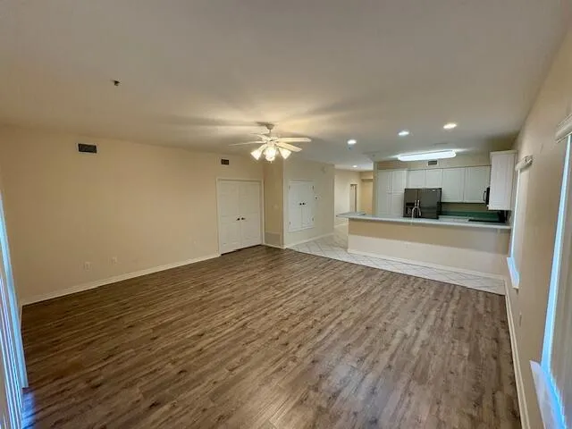 a view of a kitchen with a sink and a refrigerator