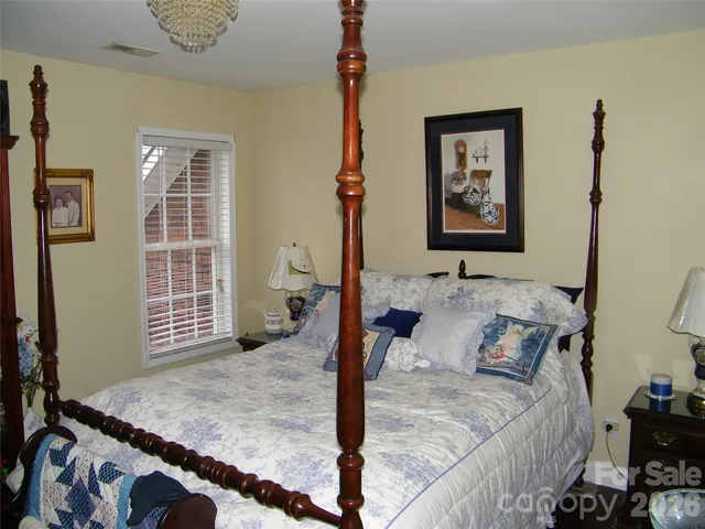 a bedroom with a bed dresser and a window