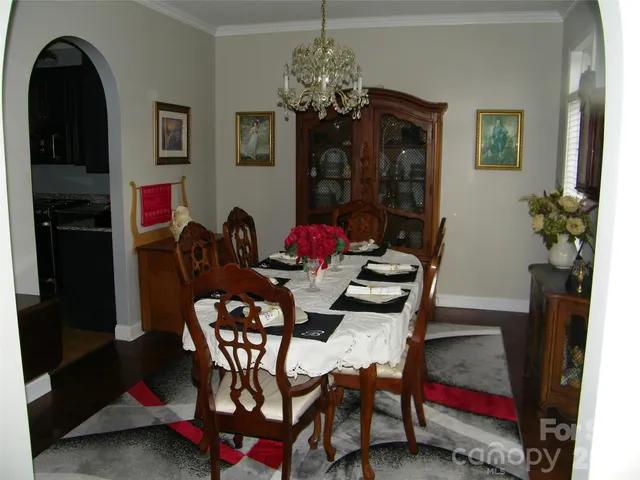 a view of a dining room with furniture and chandelier