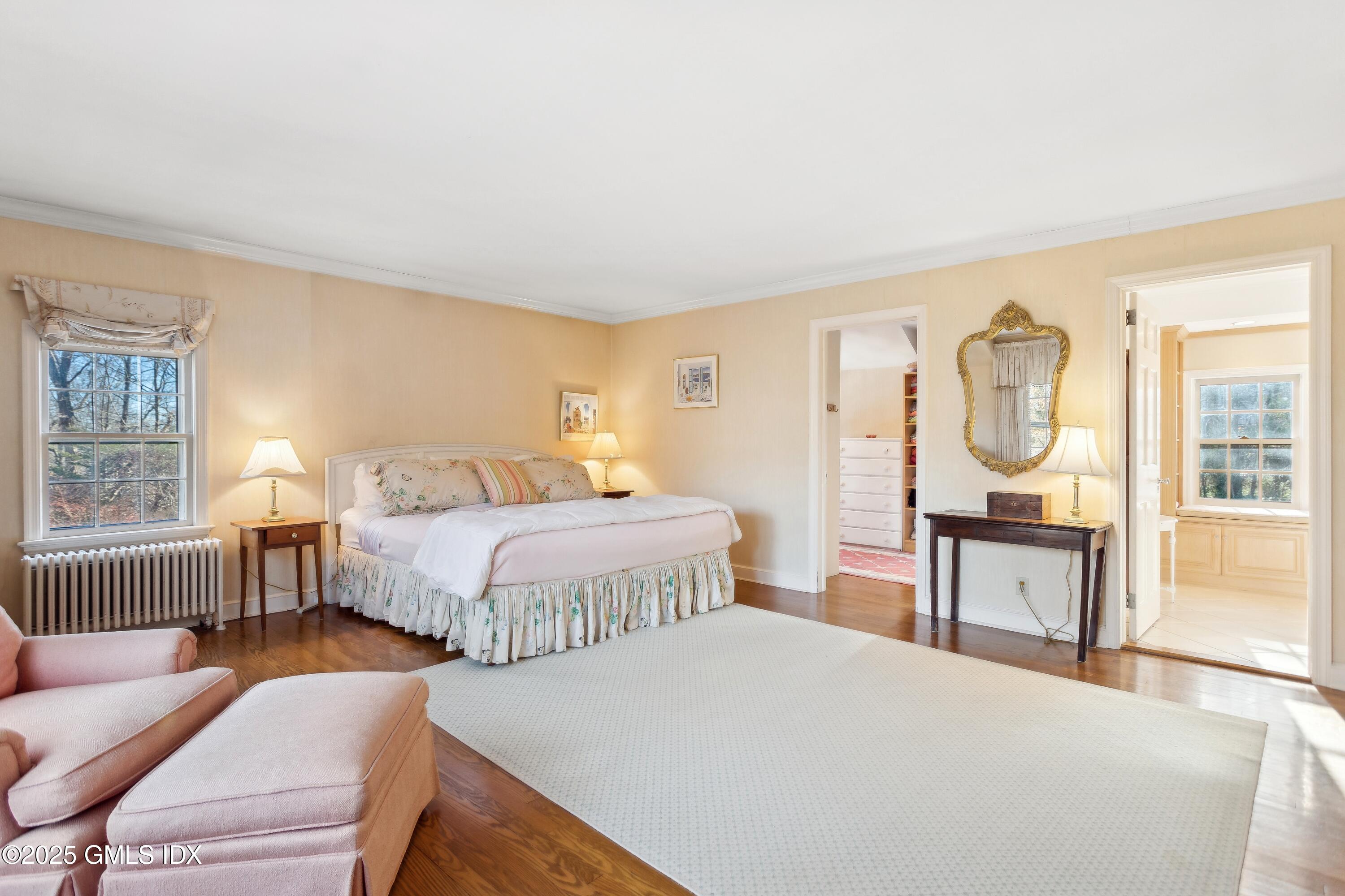 2 Laurel Road Stamford, CT 06903 - Photo 11 of 24 a bedroom with a bed a mirror on dresser and a window