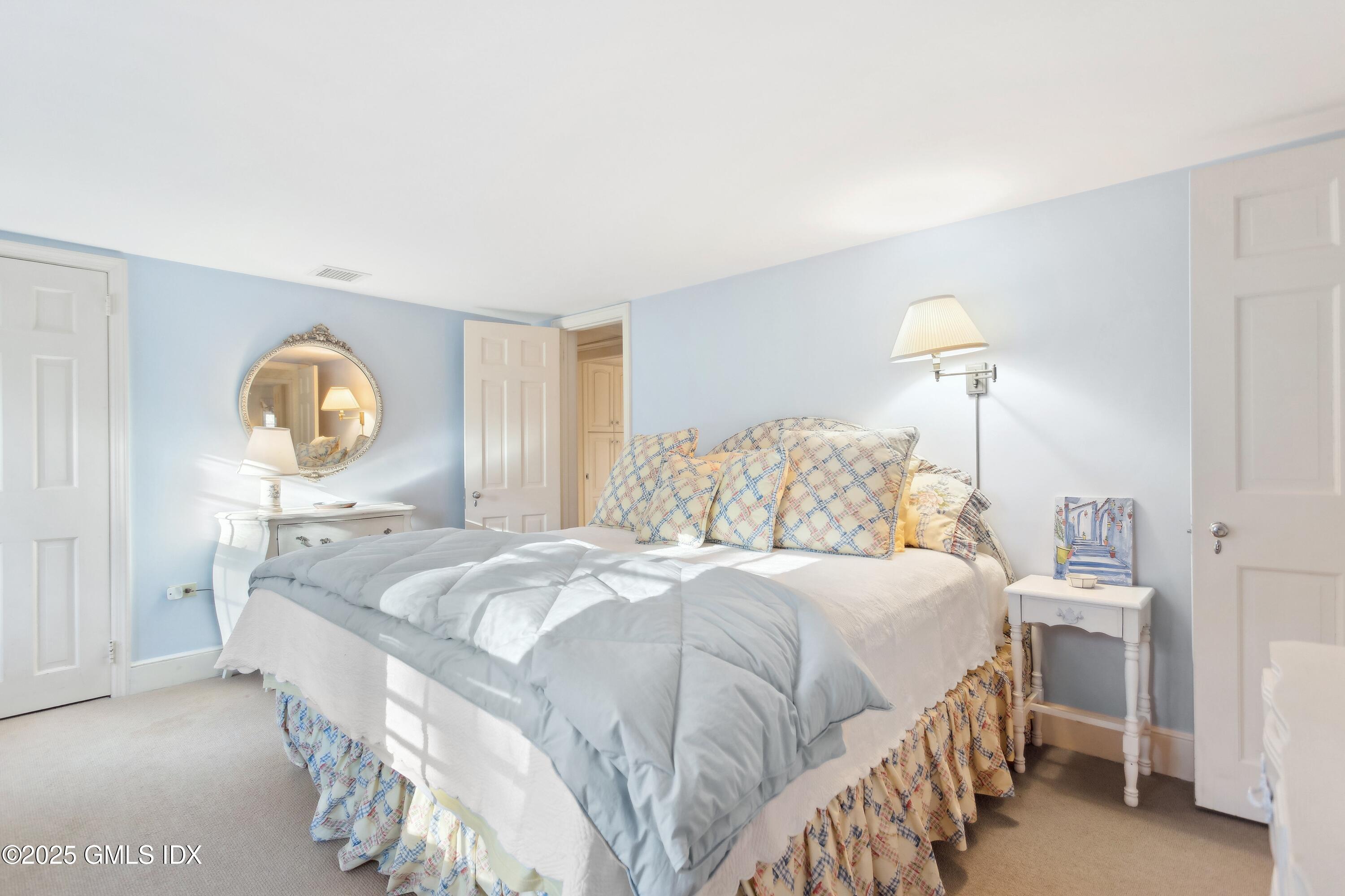 2 Laurel Road Stamford, CT 06903 - Photo 12 of 24 a bedroom with a bed and a lamp on dresser