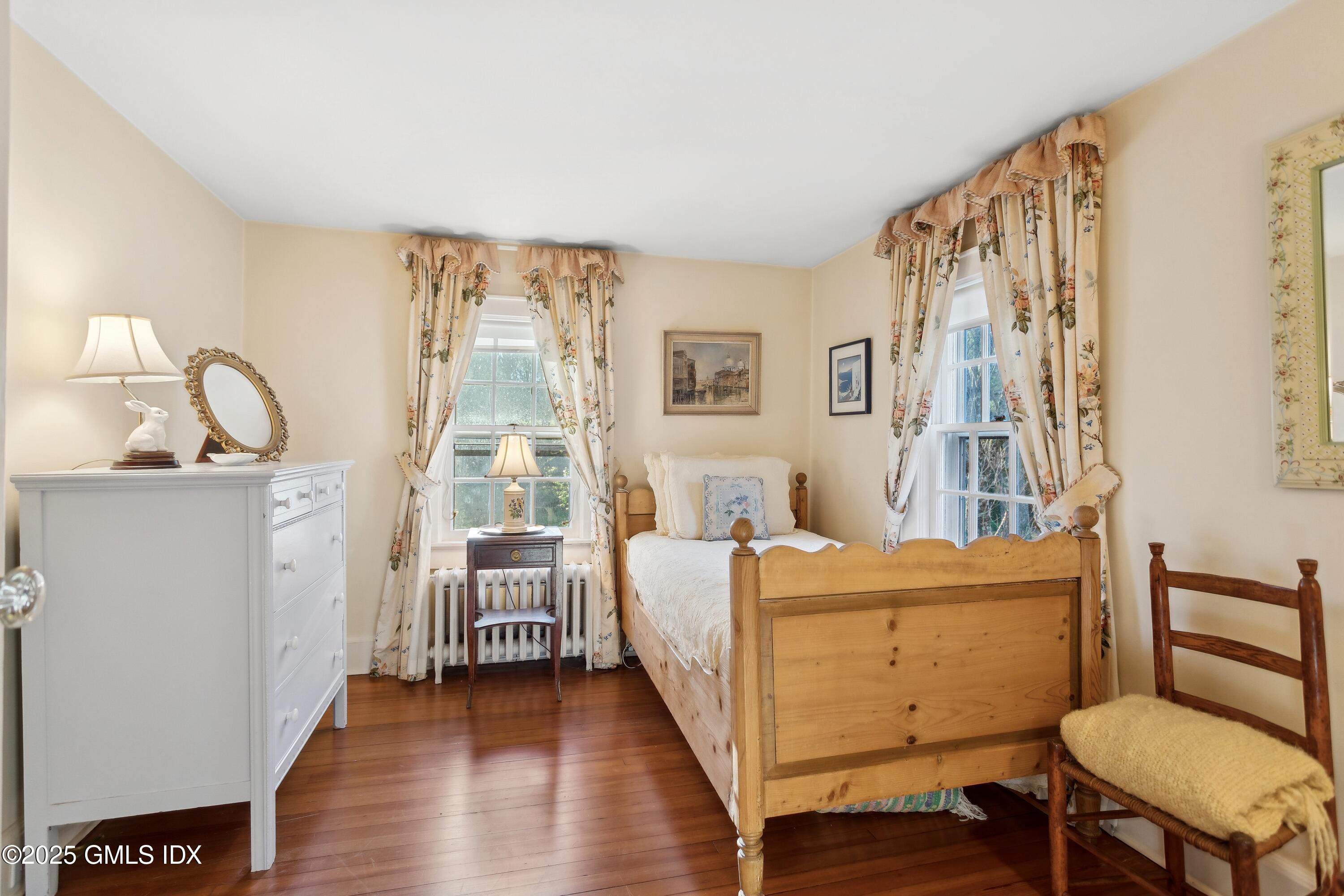 2 Laurel Road Stamford, CT 06903 - Photo 14 of 24 a room with a bed and wooden floor