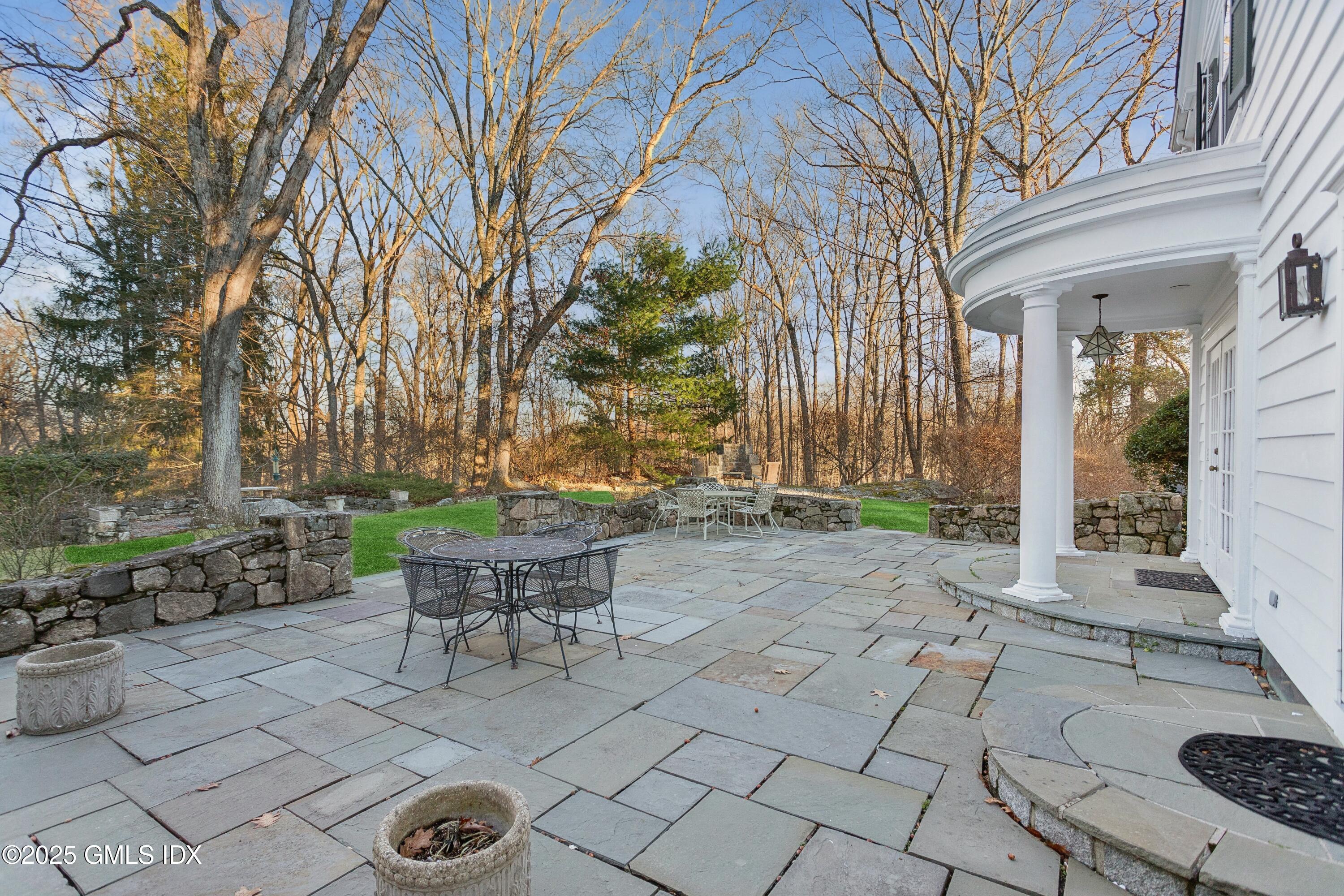 2 Laurel Road Stamford, CT 06903 - Photo 19 of 24 a view of a patio with table and chairs and potted plants
