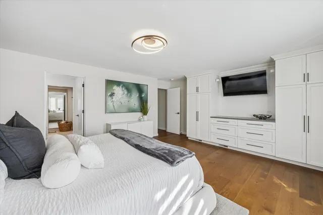 a bedroom with a bed and a television