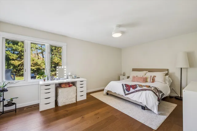 a bedroom with a bed and a desk