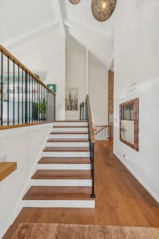 a view of entryway and hall with wooden floor