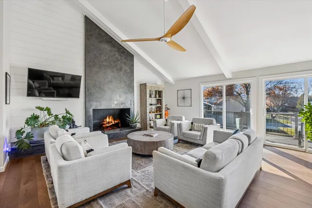 a living room with furniture a flat screen tv and a fireplace