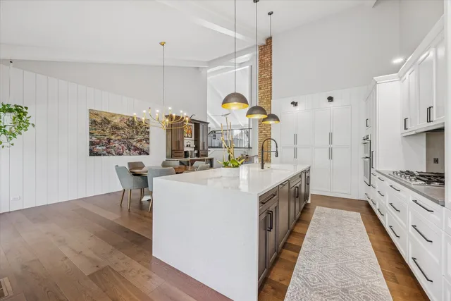 a large white kitchen with a large window