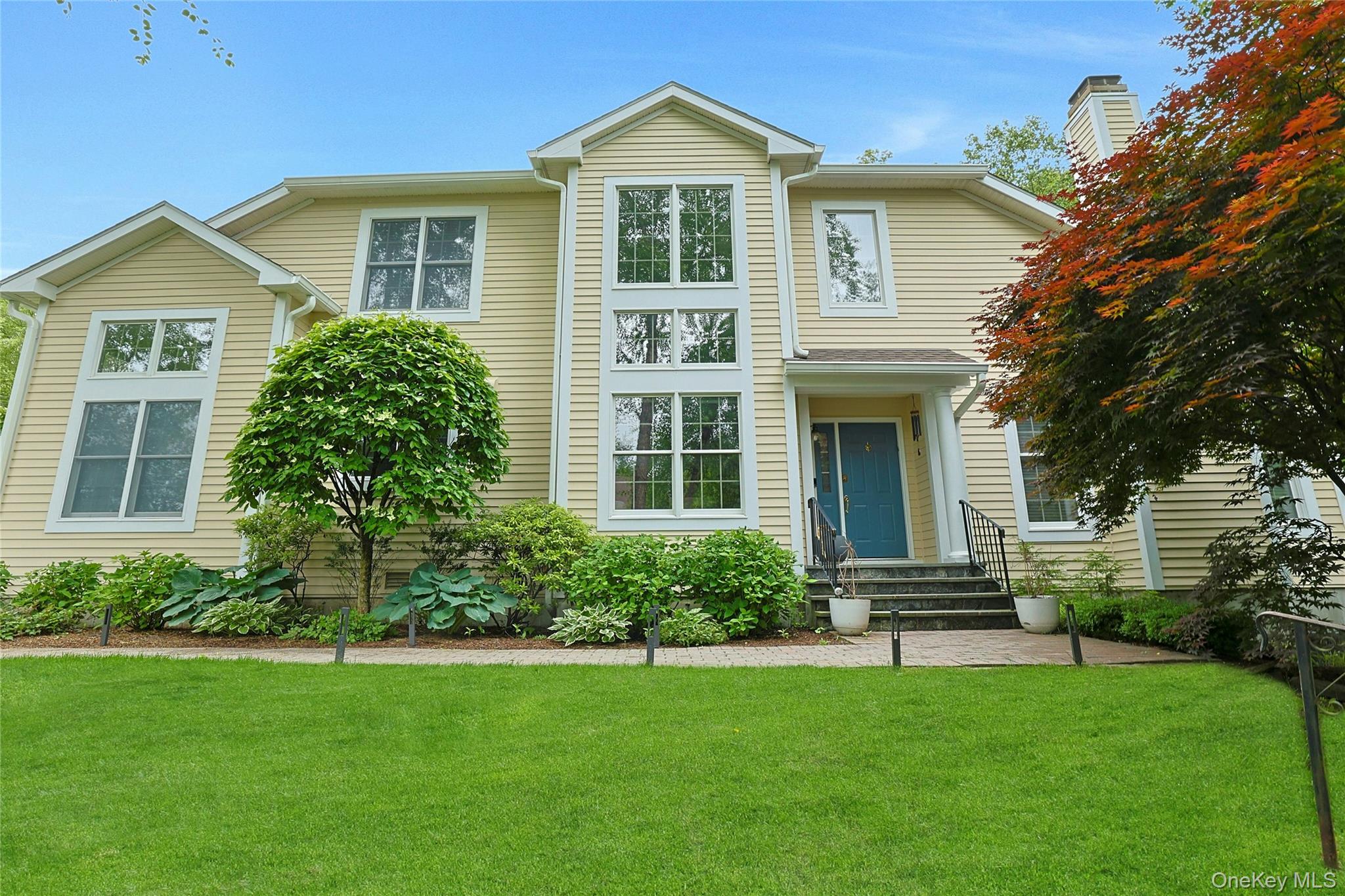 a front view of a house with a yard