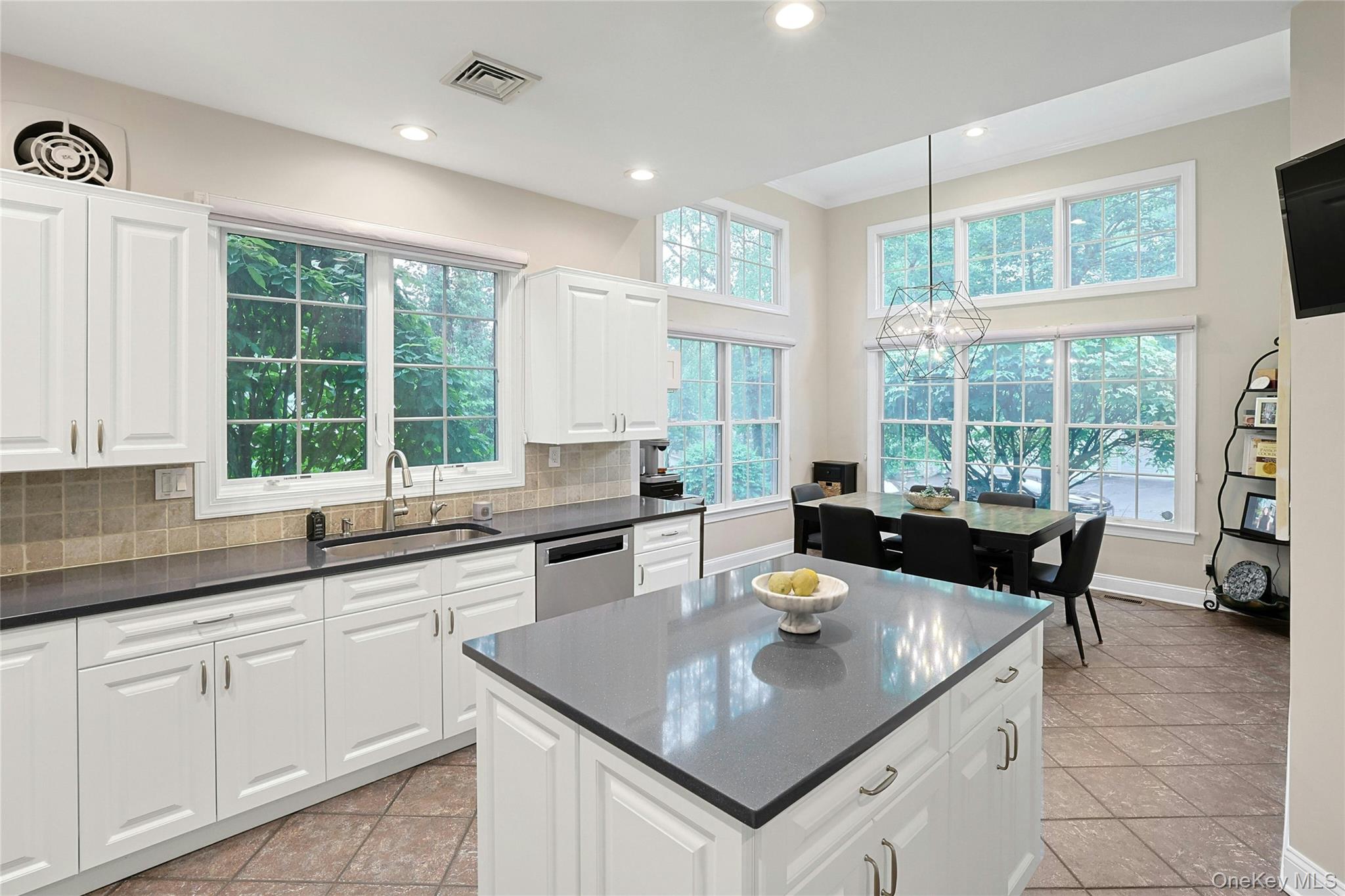 26 Agnew Farm Road Armonk, NY 10504 - Photo 14 of 28 a kitchen with a stove a sink a dining table and chairs