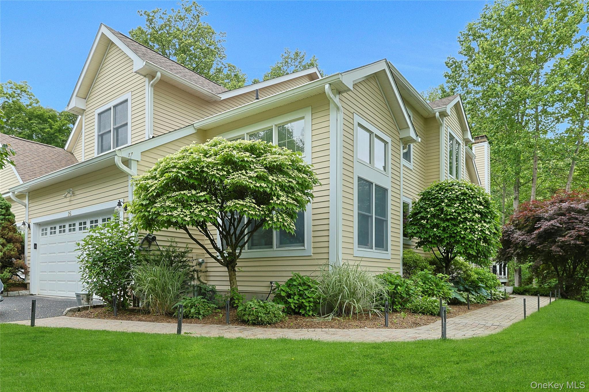 26 Agnew Farm Road Armonk, NY 10504 - Photo 3 of 28 a front view of a house with a garden
