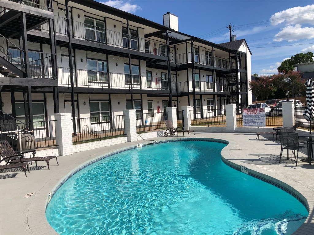 a view of a house with swimming pool and sitting area