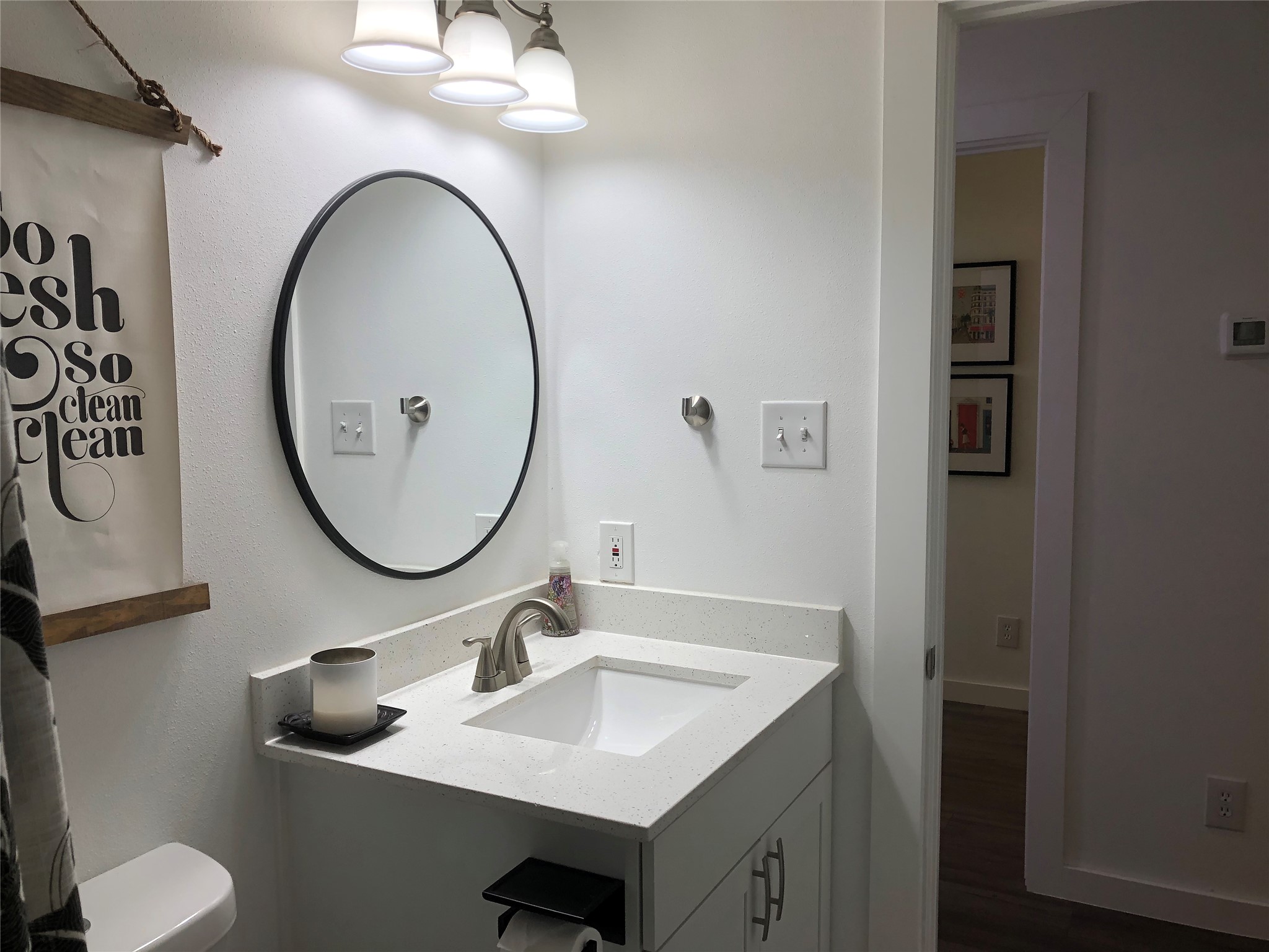 6409 Burns Street, Unit 306 Austin, TX 78752 - Photo 11 of 24 a bathroom with a toilet sink and mirror