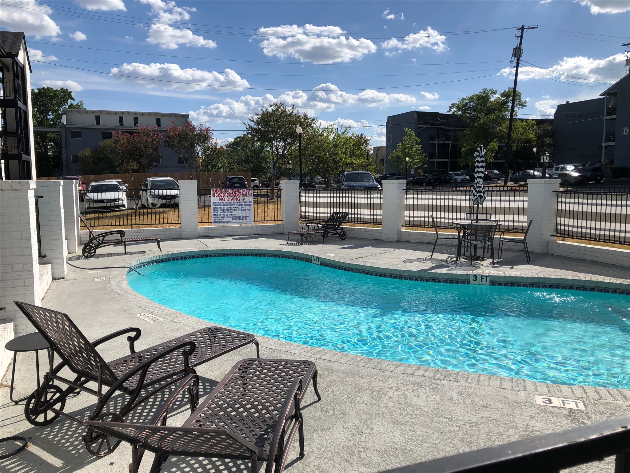 6409 Burns Street, Unit 306 Austin, TX 78752 - Photo 18 of 24 a swimming pool with outdoor seating and yard