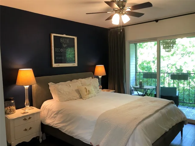 a bedroom with a bed and a lamp