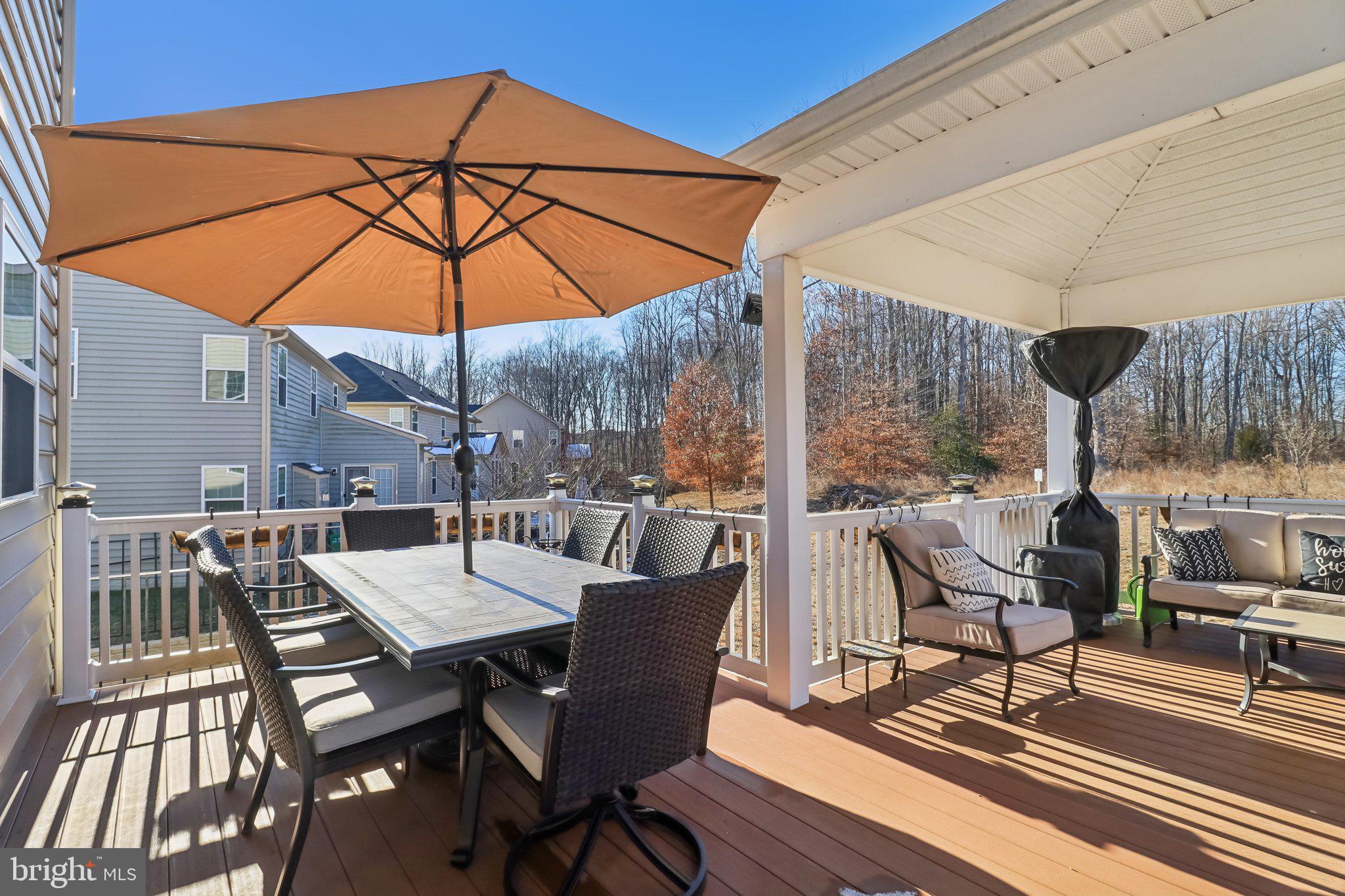 14013 Wheel Wright Place Accokeek, MD 20607 - Photo 31 of 38 a view of a patio with a table and chairs under an umbrella