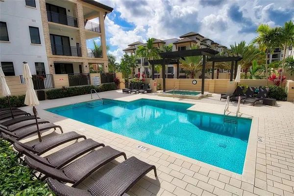 a view of a house with swimming pool and sitting area