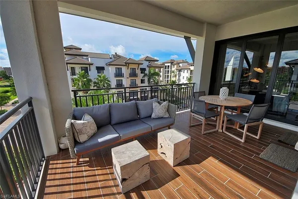 a view of a balcony with a table and chairs