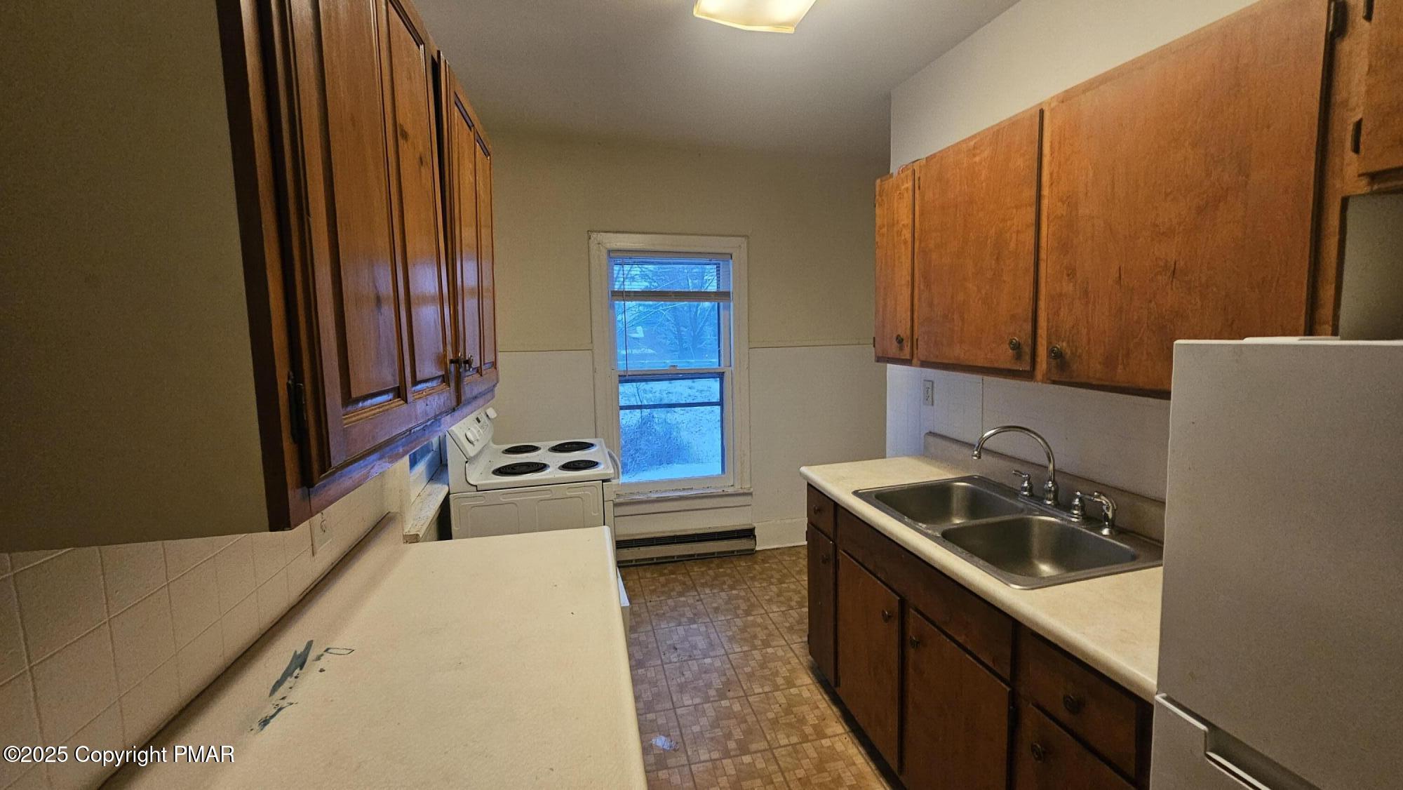 121 Hardytown Road Cresco, PA 18326 - Photo 16 of 35 a kitchen with a sink a stove and cabinets