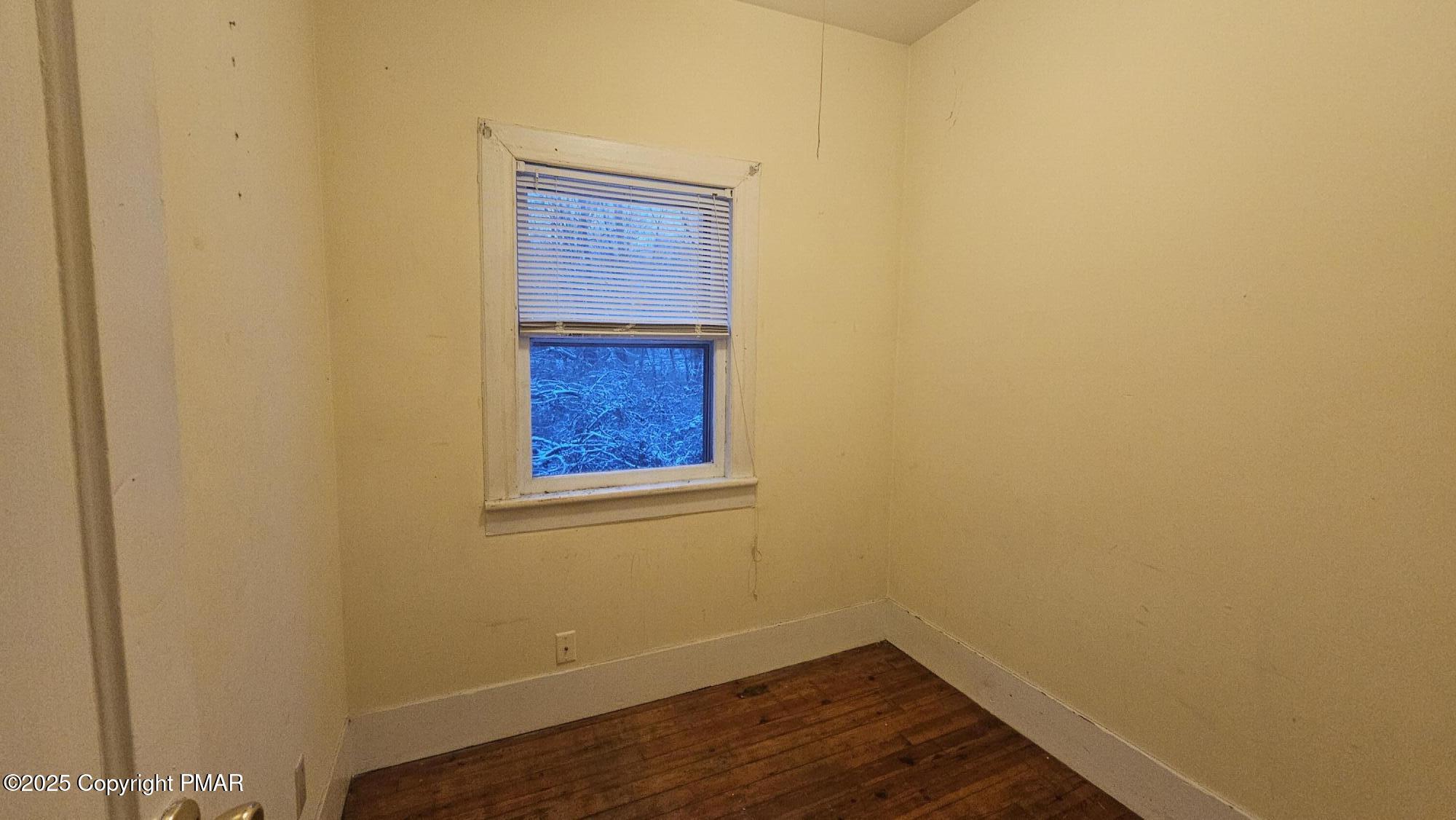 121 Hardytown Road Cresco, PA 18326 - Photo 17 of 35 a view of an empty room with wooden floor and a window