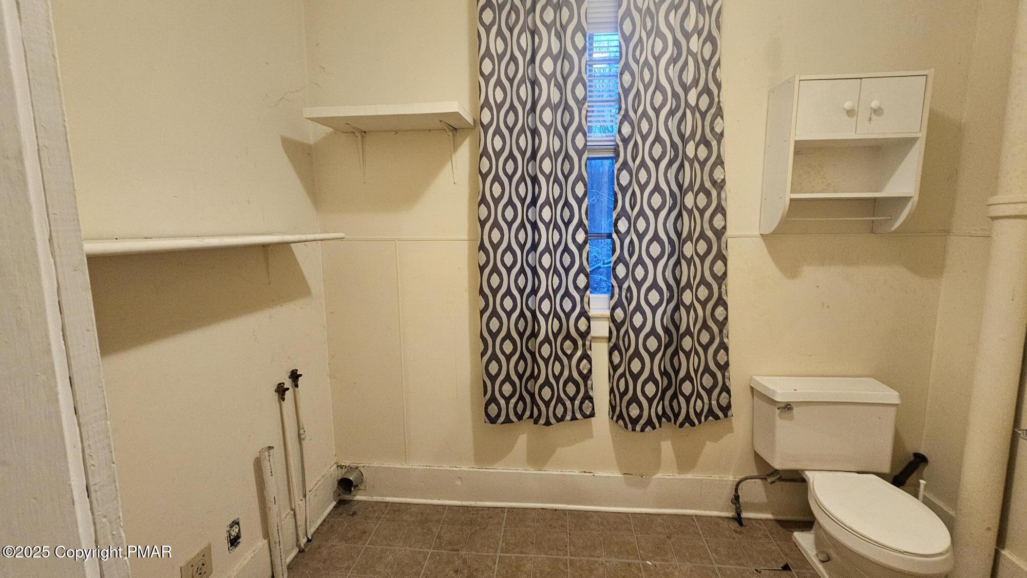 121 Hardytown Road Cresco, PA 18326 - Photo 18 of 35 a white toilet sitting next to a shower curtain