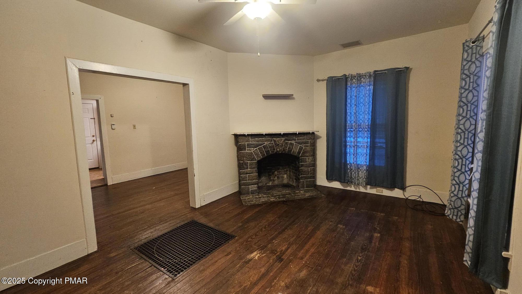 121 Hardytown Road Cresco, PA 18326 - Photo 7 of 35 a view of an empty room with wooden floor and a fireplace