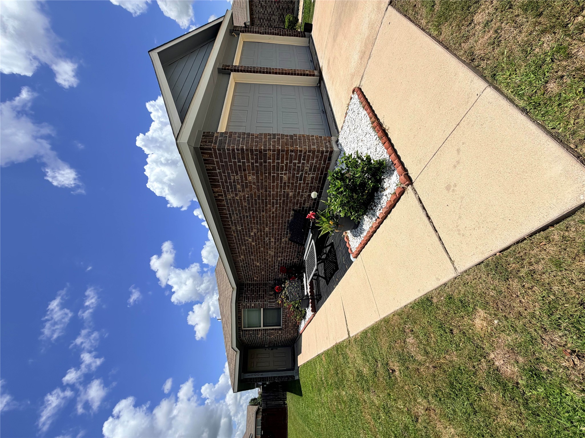 13004 Tinker Street Manor, TX 78653 - Photo 1 of 9 A classic brick exterior and well-maintained landscaping create inviting curb appeal.