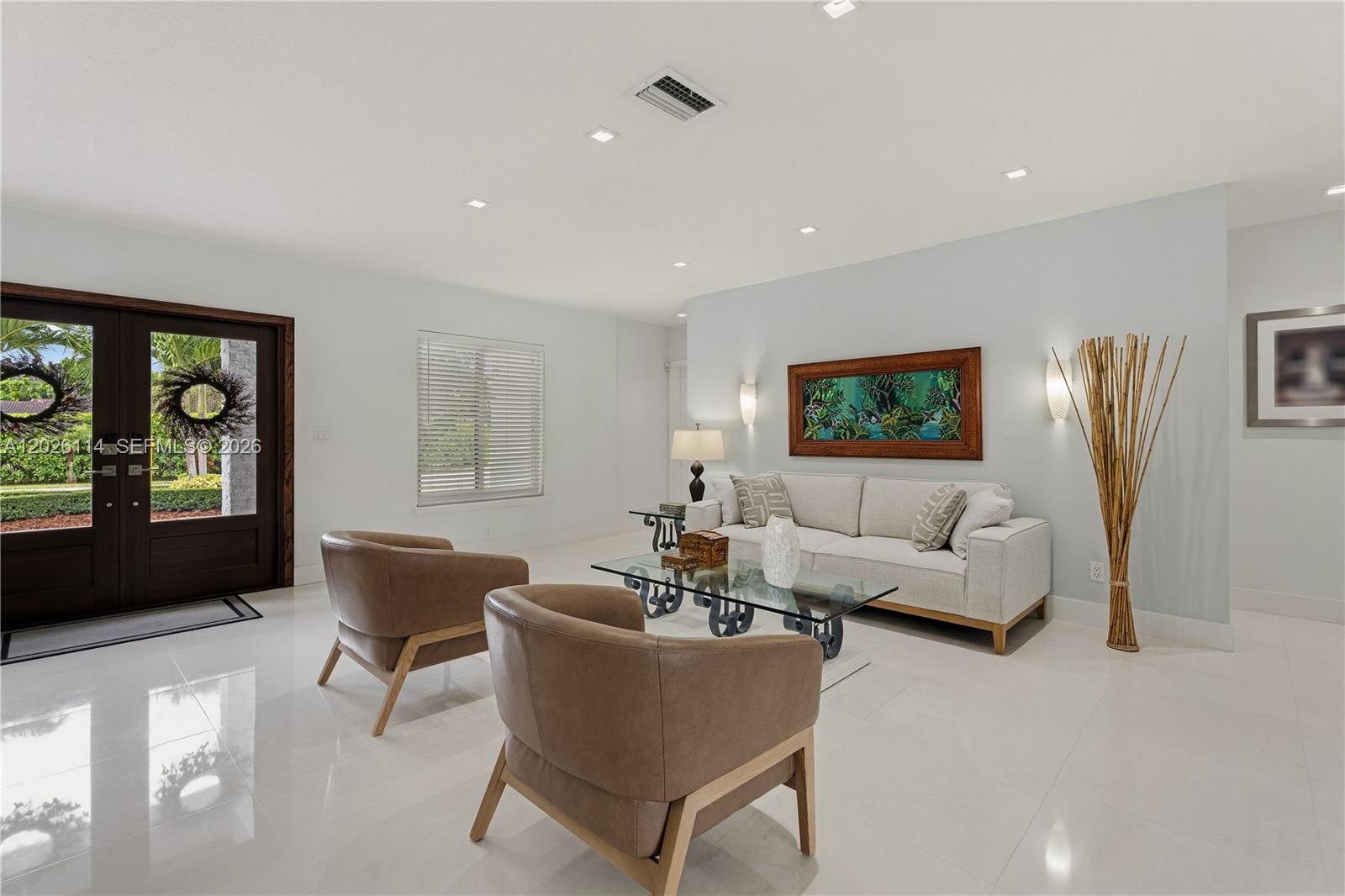 9641 Southwest 66th Street Miami, FL 33173 - Photo 11 of 57 a living room with furniture a large window and a flat screen tv
